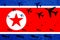 Air strike by North Korean aviation bombs. Modern North Korean warplanes drop bombs on the background of the flag. Bombing Of Nort
