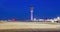 Air Traffic Control Tower after with fueling trucks on soft blue night sky