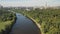 Air view of the metropolis on a summer day from the floodplain of the river and green areas