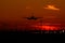 Airbus A320 airplane silhouette at sunset , final approach landing