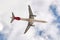 Airbus A321 of the Iberia airline seen with a low angle view just after take off in cloudy blue sky