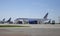 Aircraft of Air France parked on a runway, cargo bay, workers conducting technical inspection