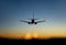 Aircraft approaching airport at sunset