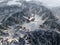 Aircraft flies over a snowy mountains