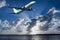 Aircraft in flight with cumulonimbus cloud in blue sky. Australia.