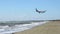 Aircraft flying over beach. Airplane arrival. Hijacked plane crash. Terrorism