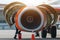 Aircraft Maintenance Mechanics Inspecting and Working on Airplane Jet Engine on Apron.