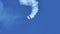 Aircraft makes smoke circles in the sky during stunt flying aerobatics acrobats