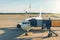 The aircraft in the parking lot is attached to the boarding bridge for boarding passengers from the terminal building