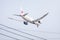 Aircraft or Plane of JAL or Japan Airlines on the sky landing to Suvarnabhumi airport. With blurry electric wires cable.