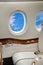 Aircraft porthole with clouds view