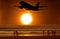 Aircraft take off and the sunset and people on the beach