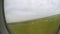 Aircraft taking off runway, gaining altitude in air, green landscape in window