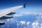 Aircraft wing blue sky, white fluffy clouds below