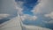 Aircraft Wing of flying in clouds and blue sky airplane. Wide view