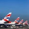 Aircrafts of British Airways on airport. Planes with flag of Great Britain as logo on tail.