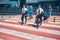 Aircrew members with travel bags crossing the road at airport