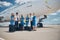 Aircrew members with travel bags standing by airplane