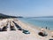 Aireal view with umbrellas and sun beds in a rocky beach in Albania.