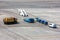 Airfield universal cleaning machine, pushback tug, passenger boarding steps vehicle, tractor with baggage carts and minivan