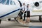 Airhostess And Pilot Standing On Private Jet\'s