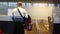Airline passenger in an airport. Rear view of a man checking in for a flight at an airport, checking in his baggage