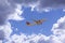 An airline plane flying in a blue sky inside big white clouds. Image with copy space