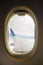 Airline window view, aircraft wing currently flying at the sky