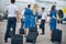 Airline workers walking down the airfield and heading to plane