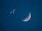 Airliner and Crescent Moon in a Dark Blue Sky