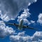 Airliner in flight with Cumulus cloud in blue sky. Australia.