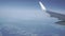 Airliner flying high above the clouds. Porthole view, aerial video