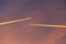 Airliner at high altitude with condesation trails.