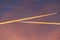 Airliner at high altitude with condesation trails.