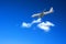 Airliner landing against a blue sky.