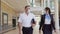 Airliner pilot and air hostess wearing face mask walking in airport terminal during the covid pandemic.