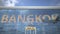 Airliner reflecting in the windows of airport terminal with BANGKOK text. 3d rendering