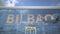 Airliner reflecting in the windows of airport terminal with BILBAO text. 3d rendering