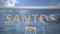 Airliner reflecting in the windows of airport terminal with SANTOS text. 3d rendering