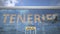 Airliner reflecting in the windows of airport terminal with TENERIFE text. 3d rendering