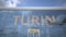 Airliner reflecting in the windows of airport terminal with TURIN text. 3d rendering