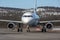 Airliner taxiing in after landing with snow covered hills in the background.