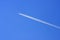 Airplane in blue sky background and white trace