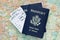 Airplane boarding passes, American passports, map