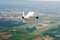 Airplane is climb flight level high view in the air, against the background of the airport of the runway, city, fields, forests an