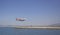 Airplane coming into land on a small runway surrounded by water in Gibraltar