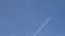 Airplane with contrail, blue sky