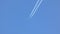 Airplane contrail - flying in the blue sky