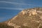 Airplane, contrails of another airplanes and cliff.