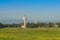 Airplane control tower on the green grass field with blue sky background